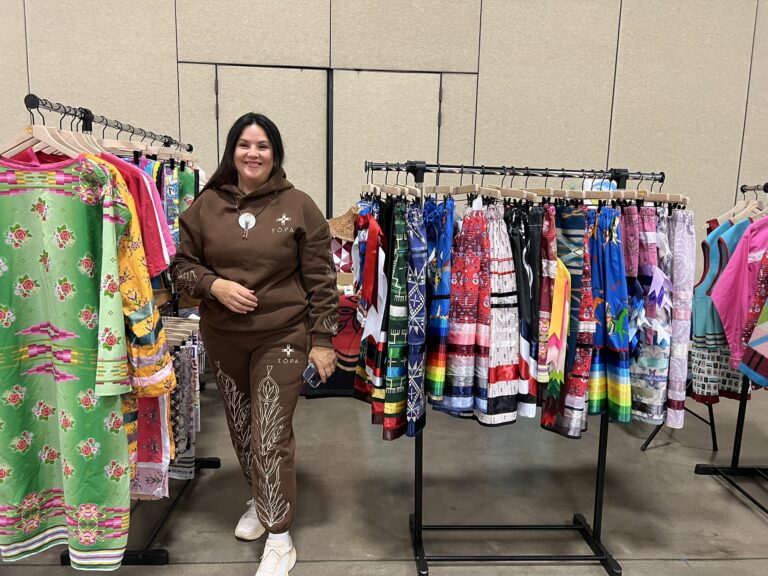 woman selling homemade clothes at vendor show